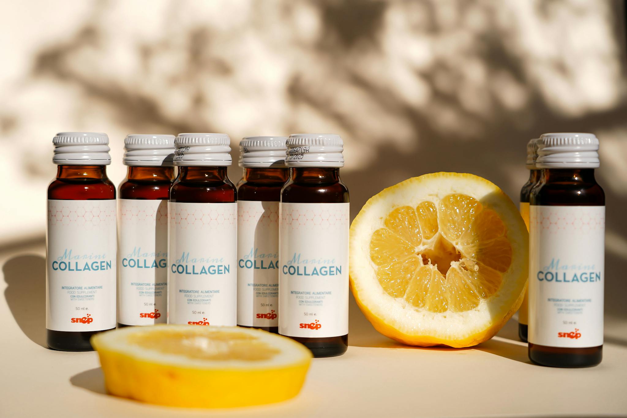 Collagen supplement bottles with lemon slice in bright light. Perfect for health and wellness themes.